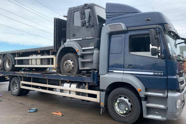 Mercedez-Benz Axor 2429 loaded for transport