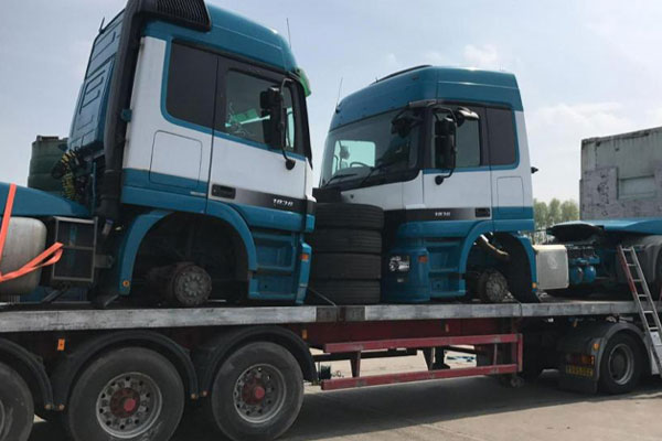 Tractor Units loaded onto a flatbed semi-trailer