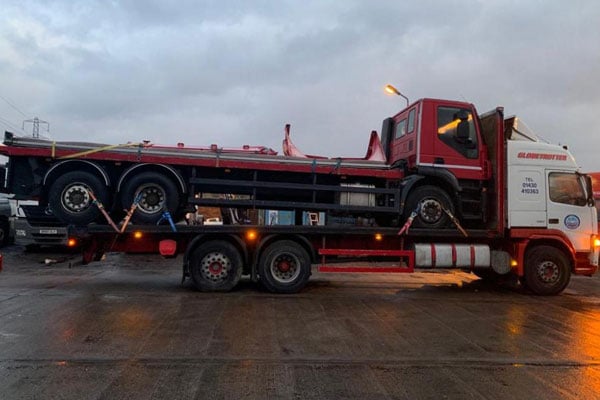 Flatbed truck being transported